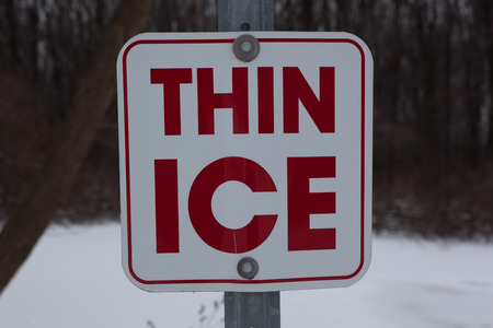 Sign warning of Thin Ice in a pondの写真素材