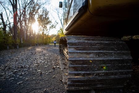 First person view of a tractor parked in a local park with an unidentified woman walking towards the...