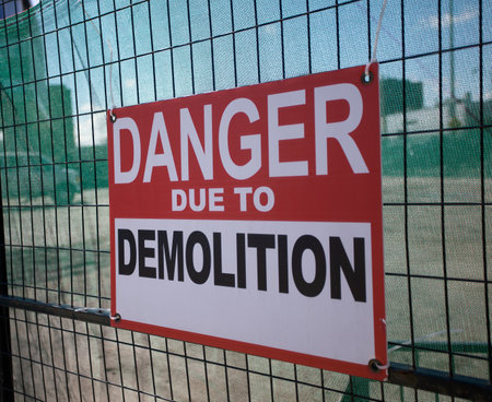 Demolition Site Warning Sign on Fenceの写真素材