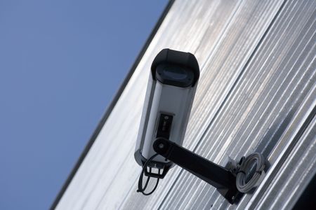 Surveillance video camera attached on a wall of a building