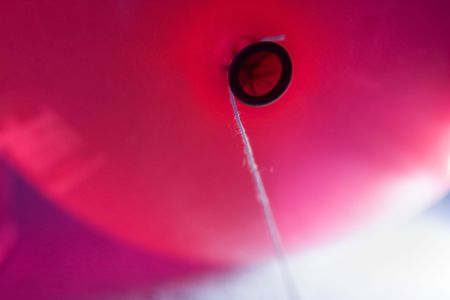 Red balloon with a threadの写真素材