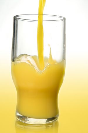 Pouring orange juice to a glassの写真素材