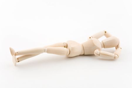 Wooden model dummy in a relaxing postureの写真素材