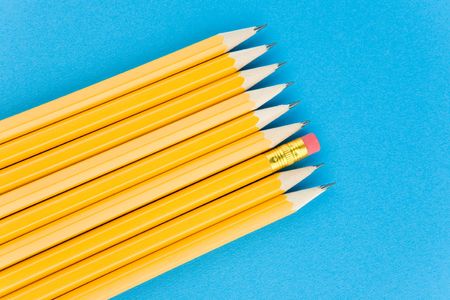 Yellow pencils on blue backgroundの写真素材
