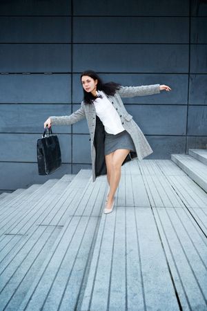 Young woman balancing on staircaseの写真素材