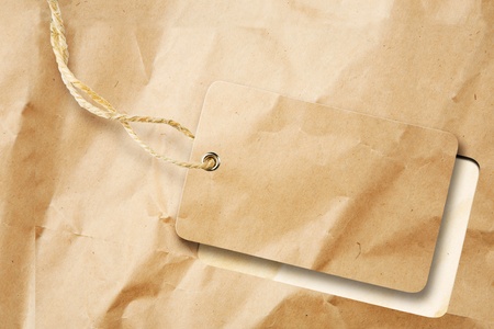 Blank tag detached from brown paperの写真素材