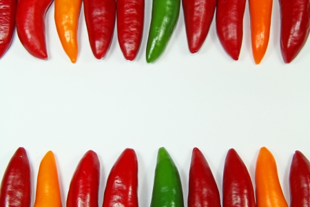 Background with colored chili peppersの写真素材