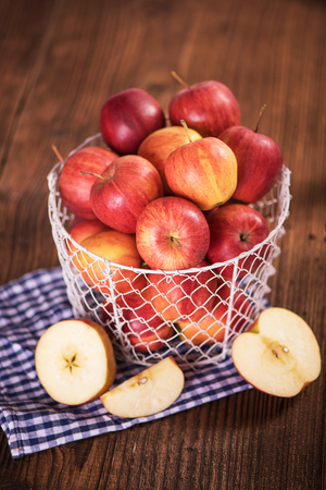 organic red apples in a metal mesh basket healthy diet weight loss conceptの写真素材