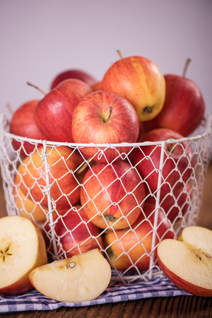 organic red apples in a metal mesh basket healthy diet weight loss conceptの写真素材