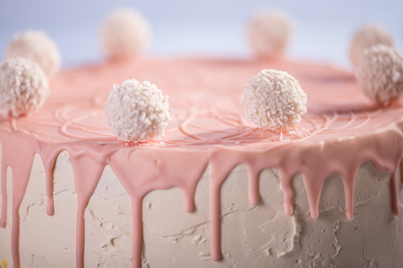 detail top of pink happy birthday cake with coconut balls on topの写真素材