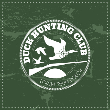 Vector hunting club emblem with a wild duck and a shotgun. White monochrome label on a dark green grunge background. Easy to edit colorsのイラスト素材