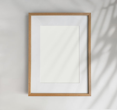 Wooden photo frame A4 size with White Photo Mat, vertical artwork on a white wall, front view. High quality photoの写真素材