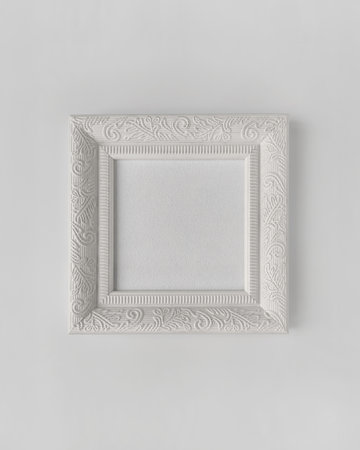 White vintage photo frame mockup, square artwork on a white wall, front view templateの写真素材