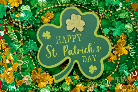 Top view of Happy St. Patrick's Day shamrock sign with festive green and gold decorations.