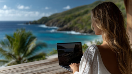a woman works on a laptop with a beautiful ocean view, a tropical island, and a wooden deck settingの素材