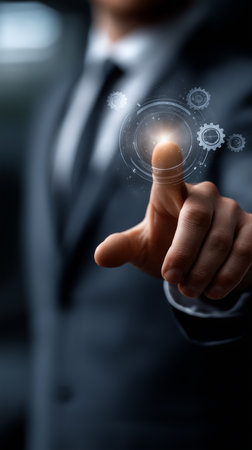 a man in a suit touches a digital interface with gears and a glowing center point of light on the screenの素材