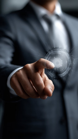 a man in a suit is pointing at a glowing digital interface, representing technology and innovationの素材
