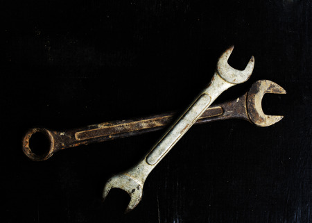 Still life of wrench on black wooden boardsの写真素材