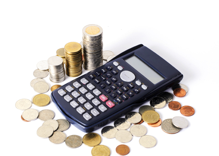 Calcuator and coins stack for business finance concept backgroundの写真素材