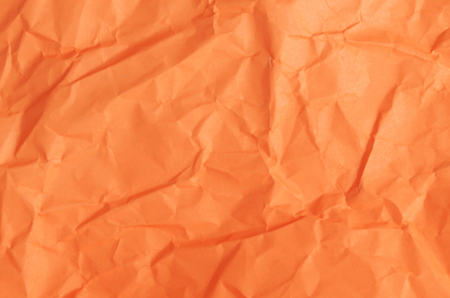 Abstract background texture with orange color paper sheetの写真素材
