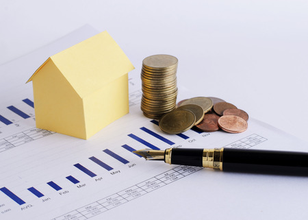 House paper and coins stack and Fountain pen for Home loans conceptの写真素材
