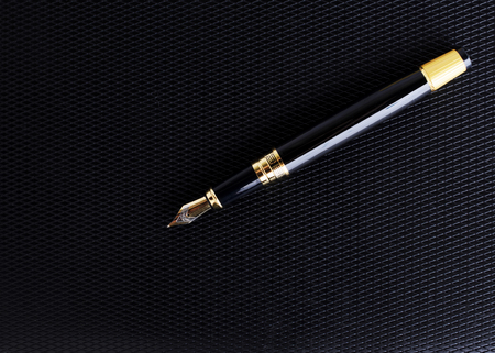 Close up of Fountain pen on leather cover book backgroundの写真素材