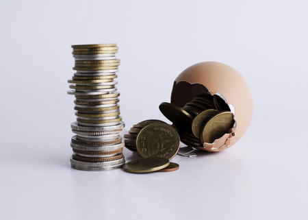Money coins stack with breken egg for loans money conceptの写真素材