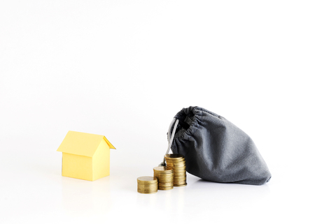 Coins stack and money bag with house paper for Home Loans conceptの写真素材