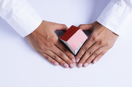 hand with heart shape and house paper for mortgage loans conceptの写真素材