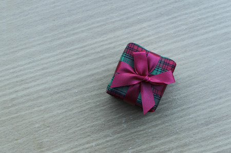 Gift box on wooden table backgrounds for chirstmas and happy new year concept