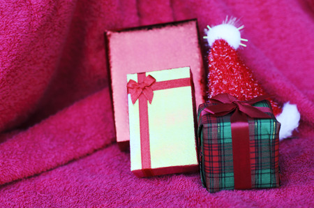 Close up of gift box with christmas decoration on red carpet backgroundsの写真素材