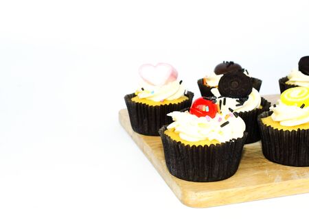 Close up of tasty cup cake on wood board on white backgroundsの写真素材