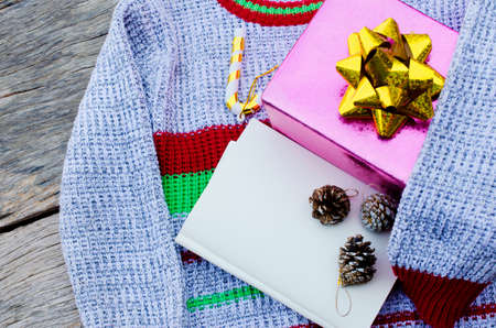 Still life of Knitting sweater and black cup on old wooden backgrounds for Christmas and happy new year conceptの写真素材