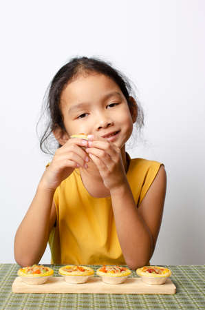Asian baby girl portrait with homemade bagery food backgrounds conceptの写真素材