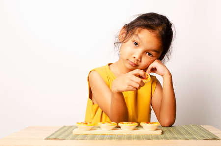 Asian baby girl portrait with homemade bagery food backgrounds conceptの写真素材