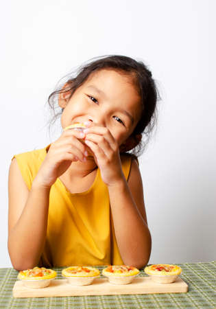 Asian baby girl portrait with homemade bagery food backgrounds conceptの写真素材