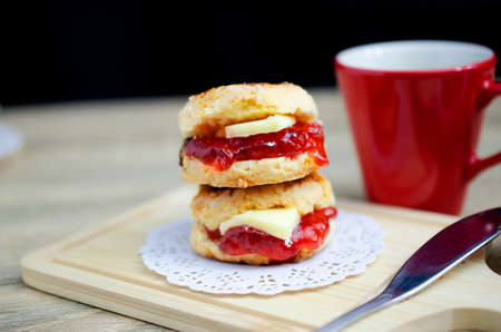 Delicious scone dessert with red cup coffee backgrounds conceptの写真素材