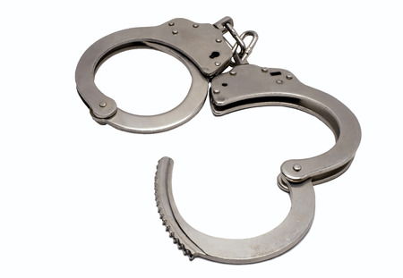 steel handcuffs lying on a white backgroundの写真素材