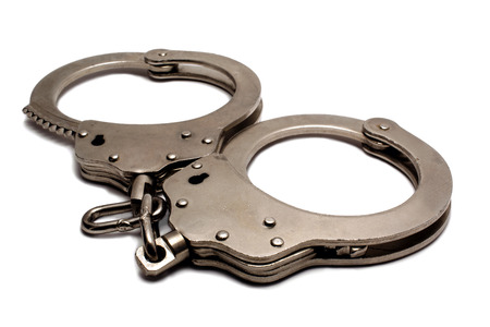 police handcuffs lying on a white backgroundの写真素材