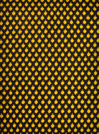 black knitted fabric with yellow peas backgroundの写真素材