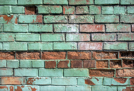 brick broken in an old blue wall backgroundの写真素材