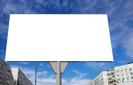 Blank billboard against a blue sky background in the cityの写真素材