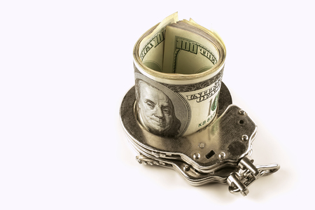 dollars and police handcuffs on a white backgroundの写真素材