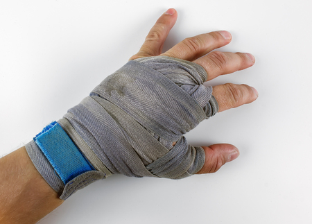 Hand in blue boxing bandage choice of an individual on a whiteの写真素材
