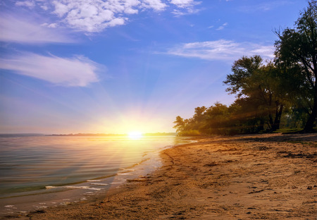 Sunrise on the sea coast in calm. sand beachの写真素材