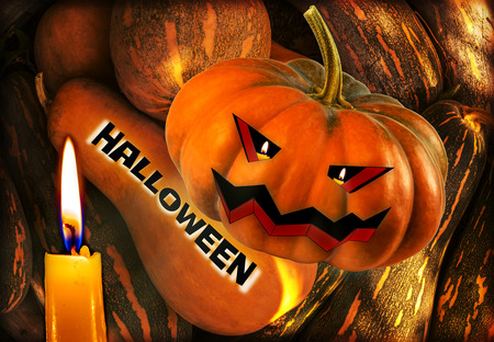 Halloween pumpkin with scary face by candlelight. inscription Halloweenの写真素材