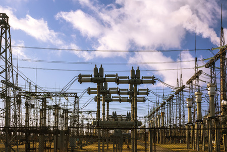 Power plant - transformation station. Multitude of cables and wires, transformers.
