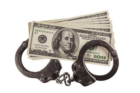 hundred-dollar bills and handcuffs isolated on a white background. justiceの写真素材