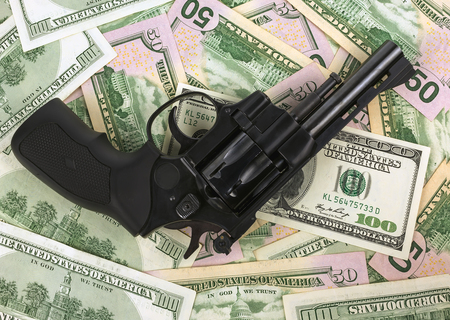 black revolver on money hundred dollar bill clouse-up
