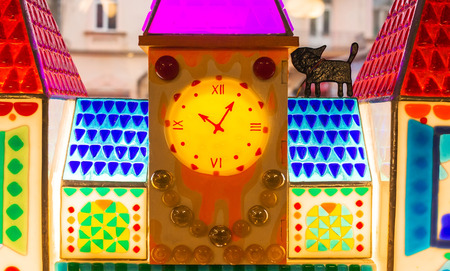caramel house with a clock and a chocolate cat on the roofの写真素材